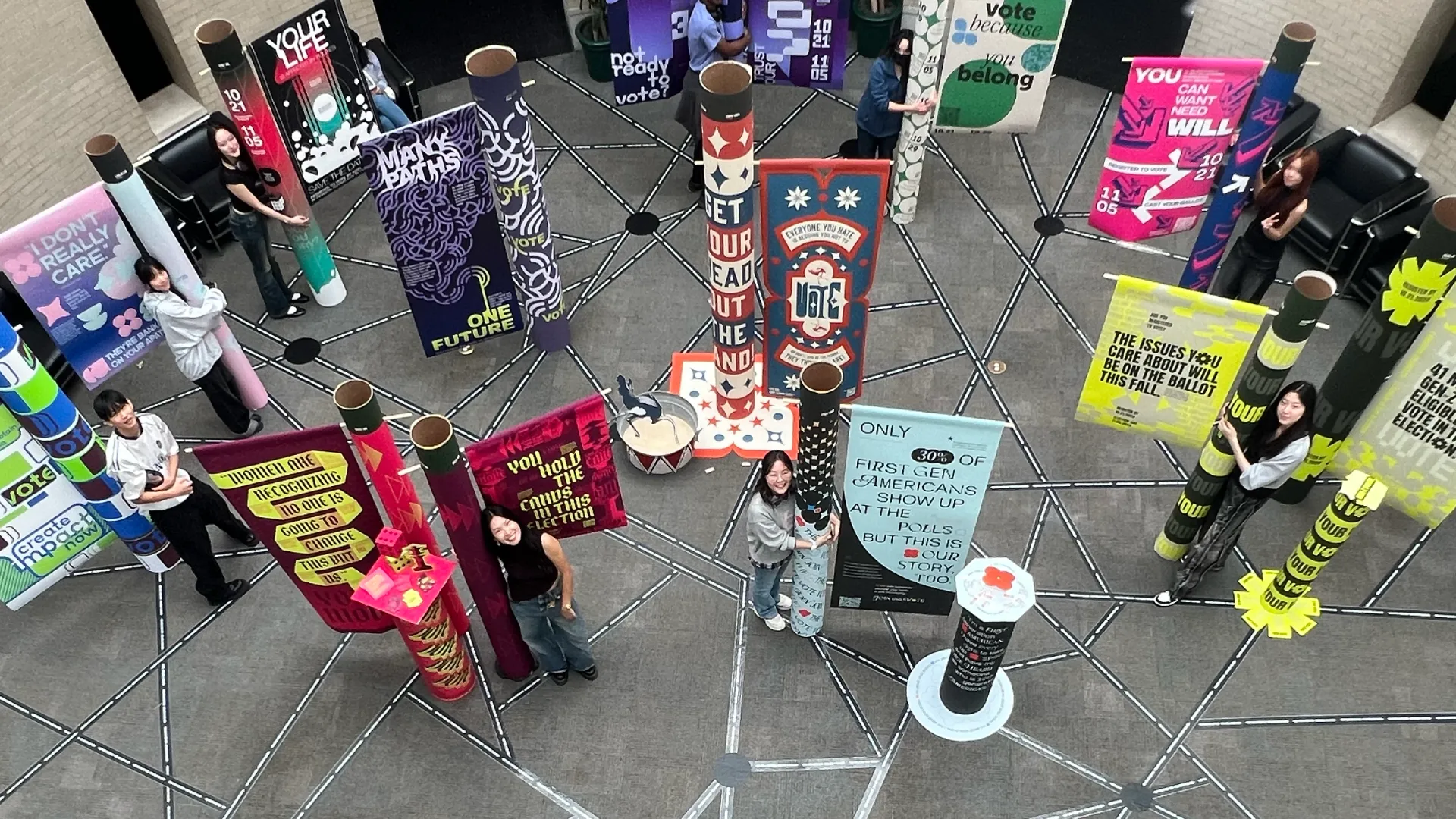 students standing with art pieces as part of a previous year's Democracy Day events