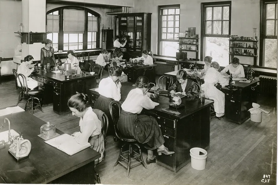 Women at Carnegie Tech study in a classroom.