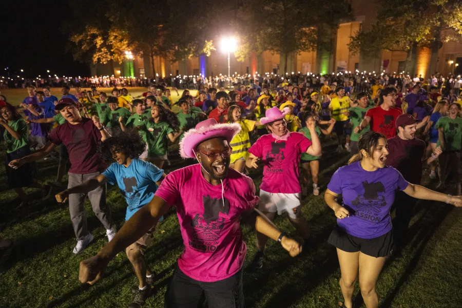 Students in a group event outside at night